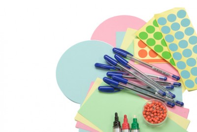 Moderator accessories are spreading out on an isolated white background. (Colorful circular and rectangular paper, pens, pins and colorful stick-on labels)