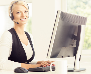 Support operator at work in a call center. Attractive female office worker. Business concept.