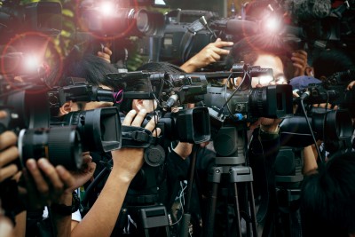 press and media camera ,video photographer on duty in public news coverage event for reporter and mass media communication